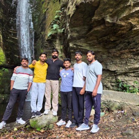 Travelers enjoying a scenic waterfall stop during the Kedarnath Himalayan journey