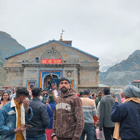 Pilgrim standing near Kedarnath Temple during the Kedarnath Yatra in Uttarakhand