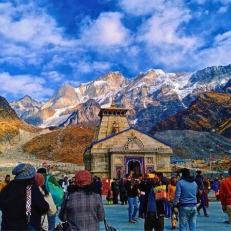 Pilgrims gathered at Kedarnath Temple with snow-covered Himalayan peaks in Uttarakhand