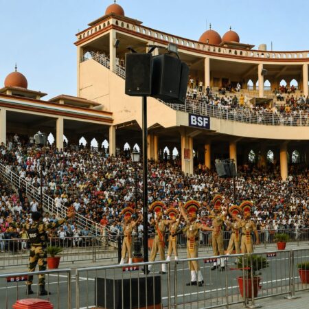 BSF soldiers performing the Beating Retreat Ceremony at the Attari-Wagah Border in Amritsar with a packed audience watching from the grandstands.