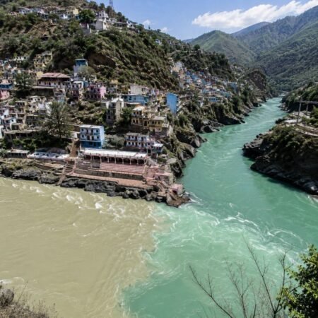 Aerial view of Devprayag Sangam showing the confluence of the Alaknanda and Bhagirathi rivers on the Kedarnath Tour Package from Rishikesh.
