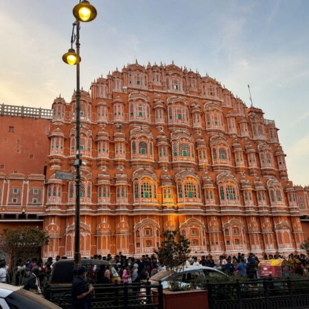 Front view of Hawa Mahal (Palace of Winds) in Jaipur, Rajasthan, showcasing its iconic pink sandstone façade and intricate windows.