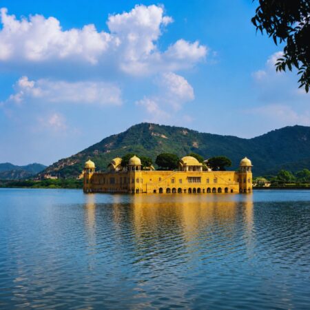 Scenic view of Jal Mahal in Man Sagar Lake, Jaipur, Rajasthan, with the historic water palace surrounded by calm waters and the Aravalli Hills in the background.