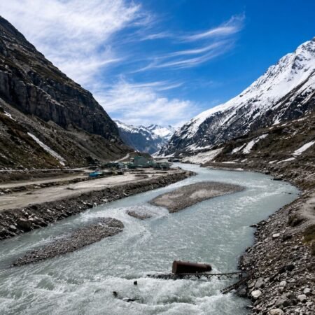 Scenic view of Sissu Valley and the Chandra River in Lahaul, Himachal Pradesh, surrounded by snow-covered Himalayan mountains and dramatic alpine landscapes.