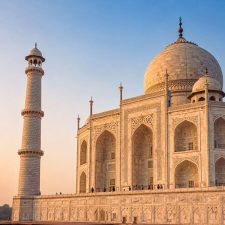 Close side view of the Taj Mahal highlighting its white marble architecture, intricate carvings, grand dome, and iconic minaret in Agra.
