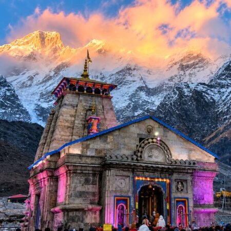 Kedarnath Temple surrounded by snow-covered Himalayan mountains during Kedarnath Yatra